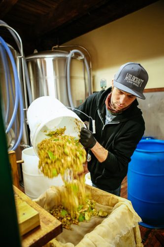 Dorian Crow of Wildcraft Cider Works prepares to press apples at the Eugene Cidery. Photo: Todd Cooper.