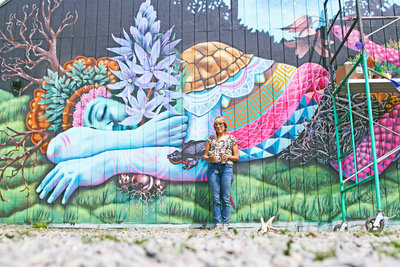 Ila Rose with her first public mural in the Whiteaker at 5th Alley and Blair Boulevard