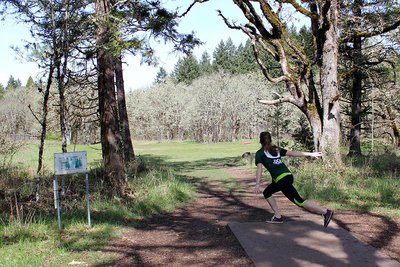 Jessica Boone, a member of the women’s disc golf team heading for a national competition, plays a round at dexter disc golf course