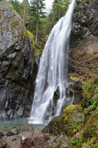 A hiker at the base of Henline Falls. Photo by John Williams