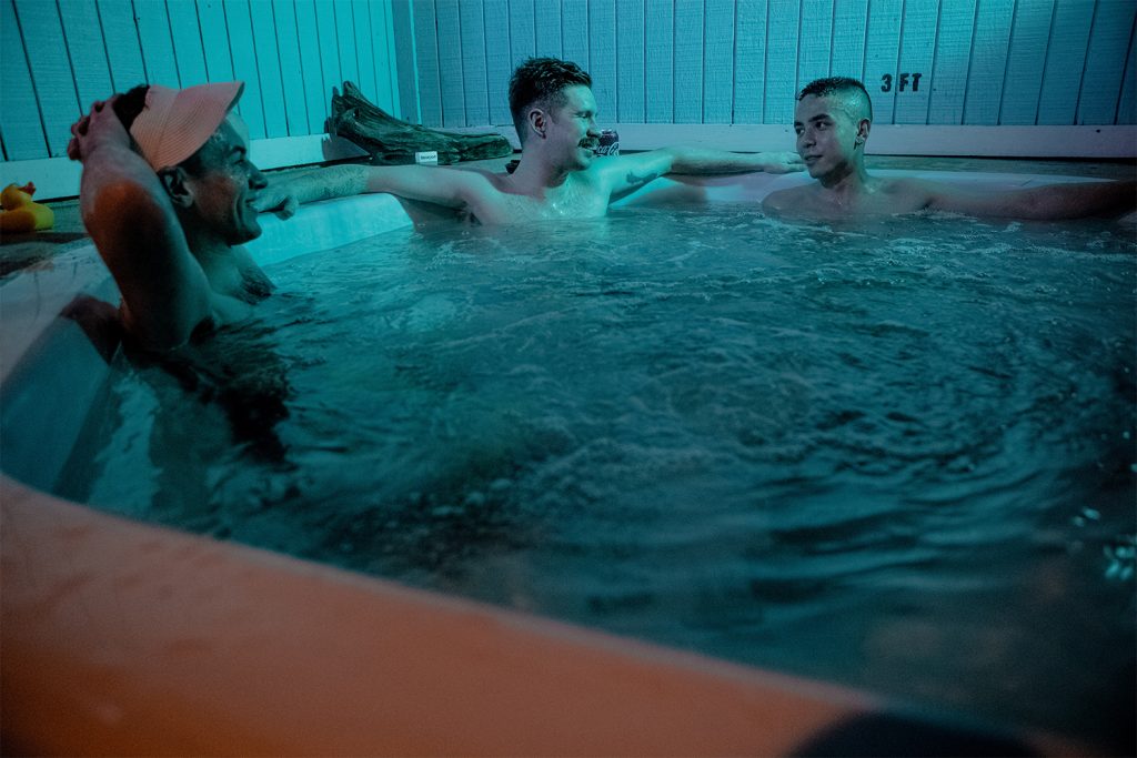 Photo of three men in a hot tub.